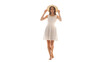 © designsMHR - A beautiful young woman wearing a white summer dress and straw hat, walking barefoot.