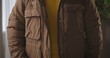 © kinomaster - Close Up of Brown Winter Jacket with Yellow Sweater
