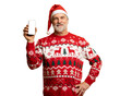 © opolja - Joyful mature man holding smartphone with empty screen, posing in Christmas sweater and Santa hat on transparent background. Winter holiday promotions. New Year 2026 Christmas
