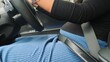 © Creativa Images - Close-Up of a Pregnant Woman Driving Safely, Securely Fastened with a Seatbelt