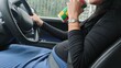 © Creativa Images - Pregnant Woman Taking a Sip of a Beverage While Driving and Wearing a Seatbelt