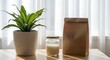 © Sahnaj - Potted green plant, jar of liquid, and brown paper bag on a wooden table with sheer curtains