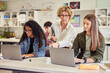 © Rido - Teacher assisting student during computer class