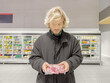 © lado2016 - Man choosing frozen food from a supermarket freezer., reading product information