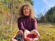 © Pavel Losevsky - Woman is holding two different types of berries in her hands. One is blue and the other is red