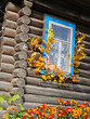 © Pavel Losevsky - Window with a blue frame and a white curtain. The window is decorated with leaves and flowers