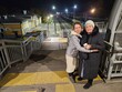 © Pavel Losevsky - Two women standing on a train tail road platform bridge pedestrian near station. One of them is wearing a white hat. The other woman is holding a cup