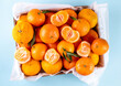© ricka_kinamoto - Fresh tangerines, mandarin clementines, raw farm organic citrus fruits, with stems and leaves, for sale at market
