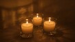 © Lasvu - Three lit candles in glass holders creating a warm, peaceful ambiance.