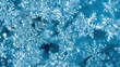© Lasvu - Close-up of snowflakes or ice crystals, frosty and intricate, with a blue background, evoking a cold, wintery scene.