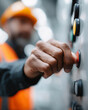 © lashkhidzetim - A man in an orange safety vest is pressing a button