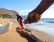 © Dani - Close-up shot of an african american man feeding a swan on a sunny beach day