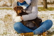 © anetlanda - Woman playing with dog during winter