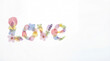 © Alicina - White background with the word 'Love' written in flower petals