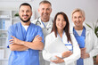 © Pixel-Shot - Team of smiling doctors in clinic