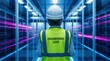 © si9nzation - Engineering lead wearing safety gear stands in a futuristic blue data center hallway with bright magenta light trails symbolizing high speed data transfer and technological connectivity
