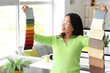 © Pixel-Shot - Asian interior designer with fabric samples in office