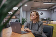 © svetograph - Businesswoman concentration laptop, female employee working seriously on digital technology in modern coworking office