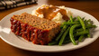 © ayatullah - A plate of meatloaf with mashed potatoes and green beans on a wooden table