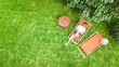 © Iuliia Sokolovska - Young girl relaxes in summer garden in sunbed deckchair on grass, relaxing outdoors in green park on weekend, aerial drone view from above