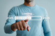 © LovelyRani - Man interacting with futuristic loading bar interface for 2025