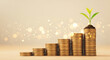 © Watcharapong - Dynamic visual of increasing stacked coins with a small plant sprouting representing financial growth, investment success, wealth building, and economic progress in a professional setting