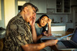 © Marko Geber - Adult couple stressed paying bills at home kitchen