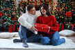 © New Africa - Happy couple with Christmas gift at home