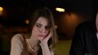 © Vlad - Young man calming down an upset woman while sitting in a restaurant with glasses of champagne. Lifestyle, relationship, date concept.