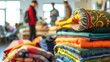 © Leo - Colorful textile store display with stacked fabrics and people in background