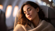 © Kateryna - Faceless young woman sleeping peacefully in luxurious first class airplane seat defocused cabin background anonymous passenger without visible face premium cabin comfort and