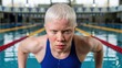 © photoplotnikov - Determined swimmer with albinism preparing for competitive pool training