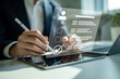 © GraphixStudio - Person using a stylus on a tablet to interact with a digital interface and checklist
