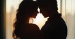 © zong - silhouetted couple embracing by a backlit window at sunset, warm golden glow and tender romantic mood
