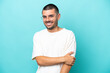 © luismolinero - Young caucasian man isolated on blue background laughing