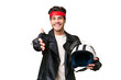 © luismolinero - Young caucasian man with a motorcycle helmet over isolated background shaking hands for closing a good deal