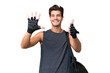 © luismolinero - Young sport caucasian man with sport bag over over isolated background counting six with fingers