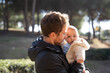© Laia Balart - Father holding baby son outdoors in the park in a sunny day