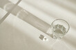 © colnihko - Pills and glass of water on table in natural morning light