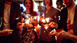 © maxbelchenko - Young friends having fun with sparklers and glasses of champagne at corporate party. Handsome men and woman spend time together, celebrating New Year in cozy space. Сoncept is festive and fun.