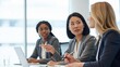 © Eve - Three diverse businesswomen collaborating during a team meeting in a modern office, focused on project strategy. Concept of multicultural teamwork, female leadership, and professional discussion.