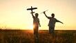 © Victoriia - child airplane, children dream airplane pilot, child kid boy girl running with toy airplane across field, working team pilots, silhouette happy children running with toy airplanes hands, happy boy