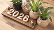© Oksana - Zero waste new year flat lay featuring wooden numbers 2026, decorative plants, and natural textures on a rustic wooden surface, promoting sustainable living and eco-friendly practices