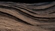 © chusnul - Layered sandstone formations with smooth, wind-sculpted ridges and striations under soft, low-angle light. eve