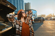 © SHOTPRIME STUDIO - woman car parking sunlight urban sunglasses portrait of relaxed traveler leaning on open trunk during golden hour glow, a candid lifestyle scene of authenticity, mindful living and emotional