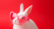 © Маргарита Пархоменко - Cute white bunny wearing pink heart-shaped sunglasses against a vibrant red background