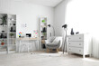 © Pixel-Shot - Photographer workplace with laptop, color wheel charts, photo camera and armchair in modern studio