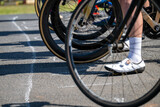 The starting line of a bicycle race, showing front wheels and feet - horizontal