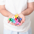 © Jo Panuwat D - World cancer day, February 4. Elderly with colorful ribbons, blue, yellow, red, green, white, pink and grey for supporting people living and illness. Health, Medical, awareness and Insurance concept