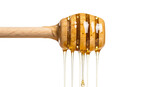 Golden honey dripping from dipper
